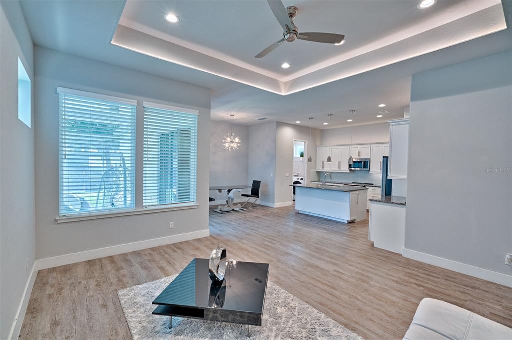 6464 Southwest 77th Street Gainesville, FL 32608 - Photo 8 of 41 a living room with kitchen island furniture and a wooden floor