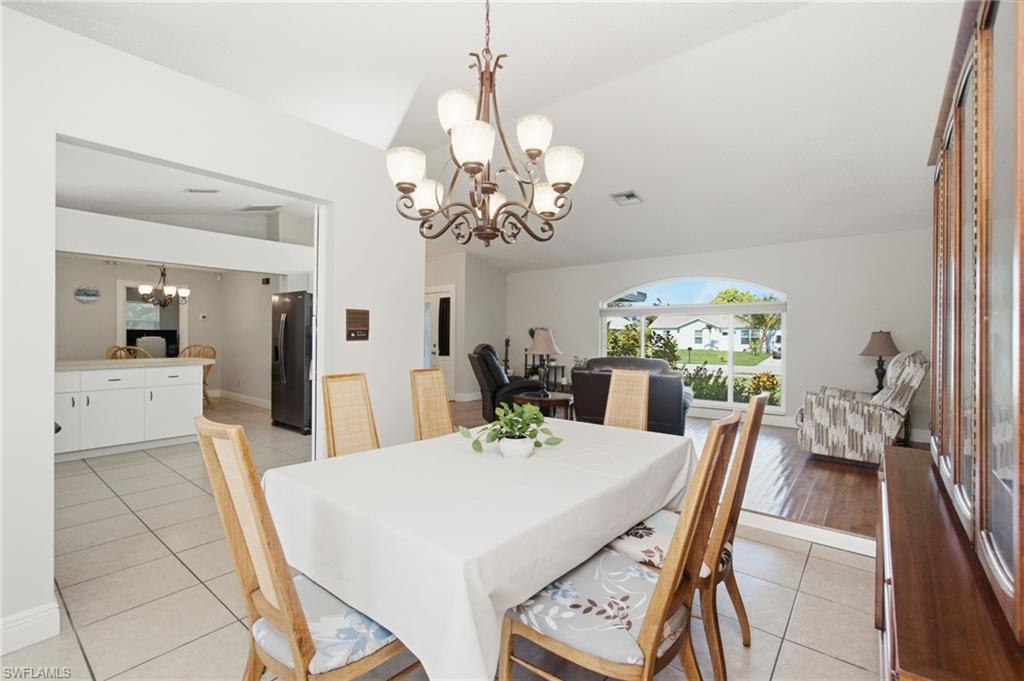3022 47th Street Southwest Naples, FL 34116 - Photo 10 of 46 Dining area featuring tiled flooring and a decorative chandelier