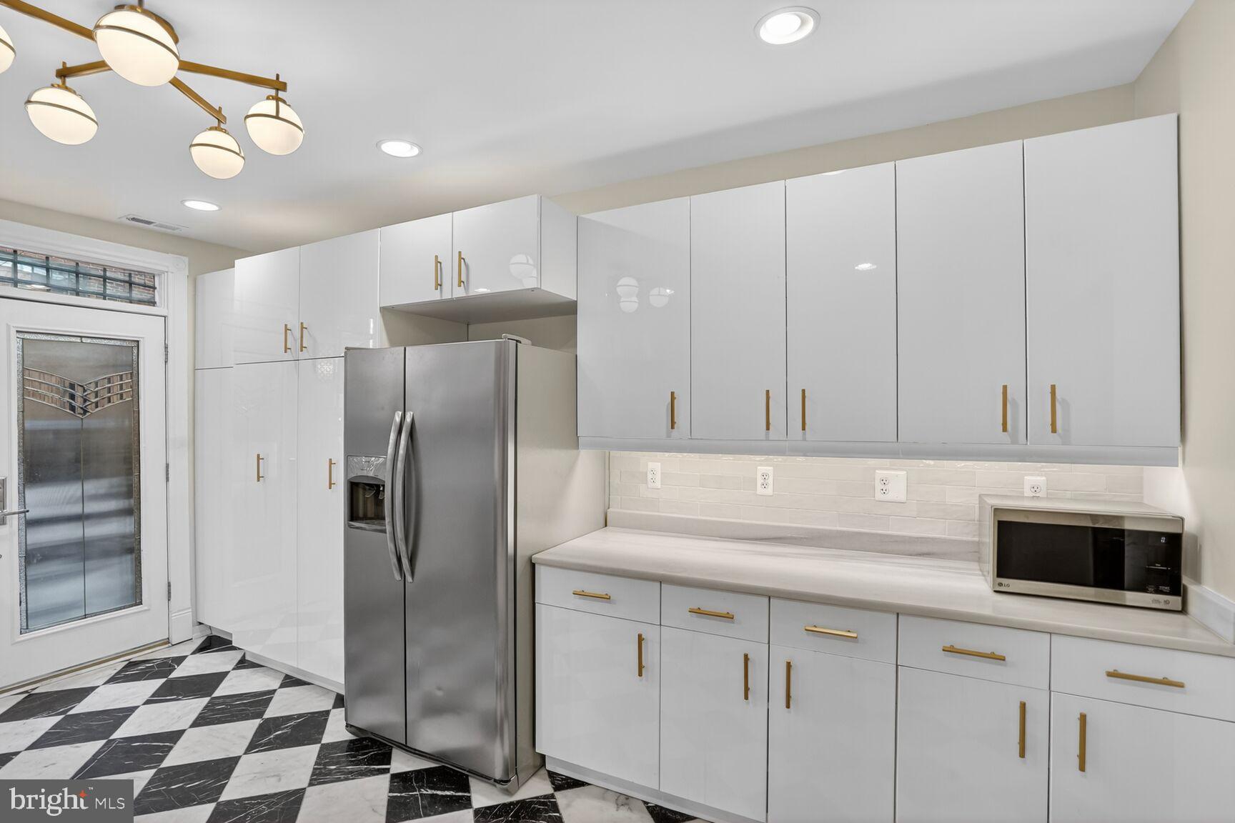 1316 Florida Avenue Northwest Washington, DC 20009 - Photo 12 of 43 a kitchen with a refrigerator sink and cabinets