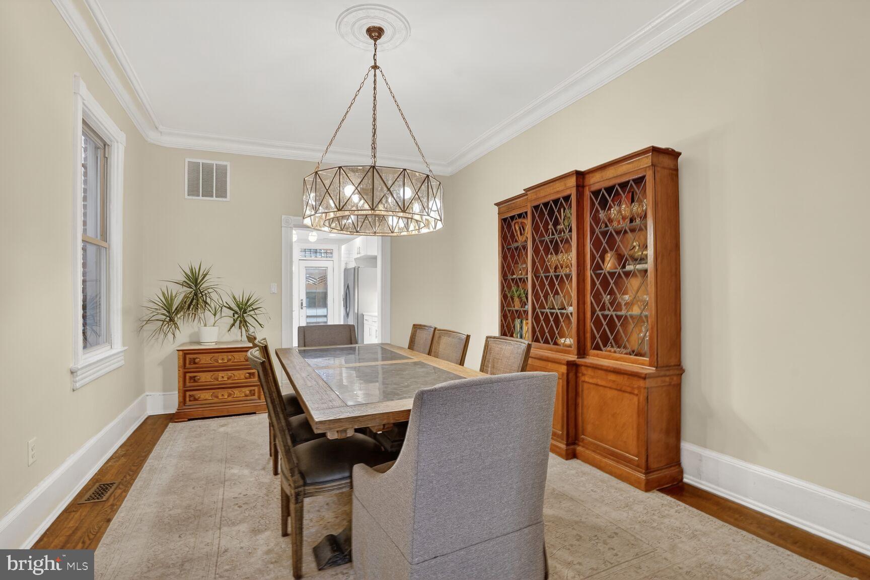1316 Florida Avenue Northwest Washington, DC 20009 - Photo 13 of 43 a dining room with chandelier and wooden floor
