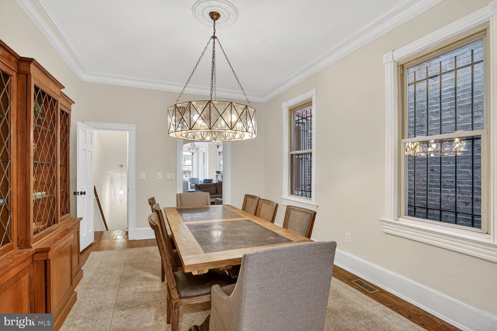 1316 Florida Avenue Northwest Washington, DC 20009 - Photo 14 of 43 a view of a dining room with furniture a chandelier and large window