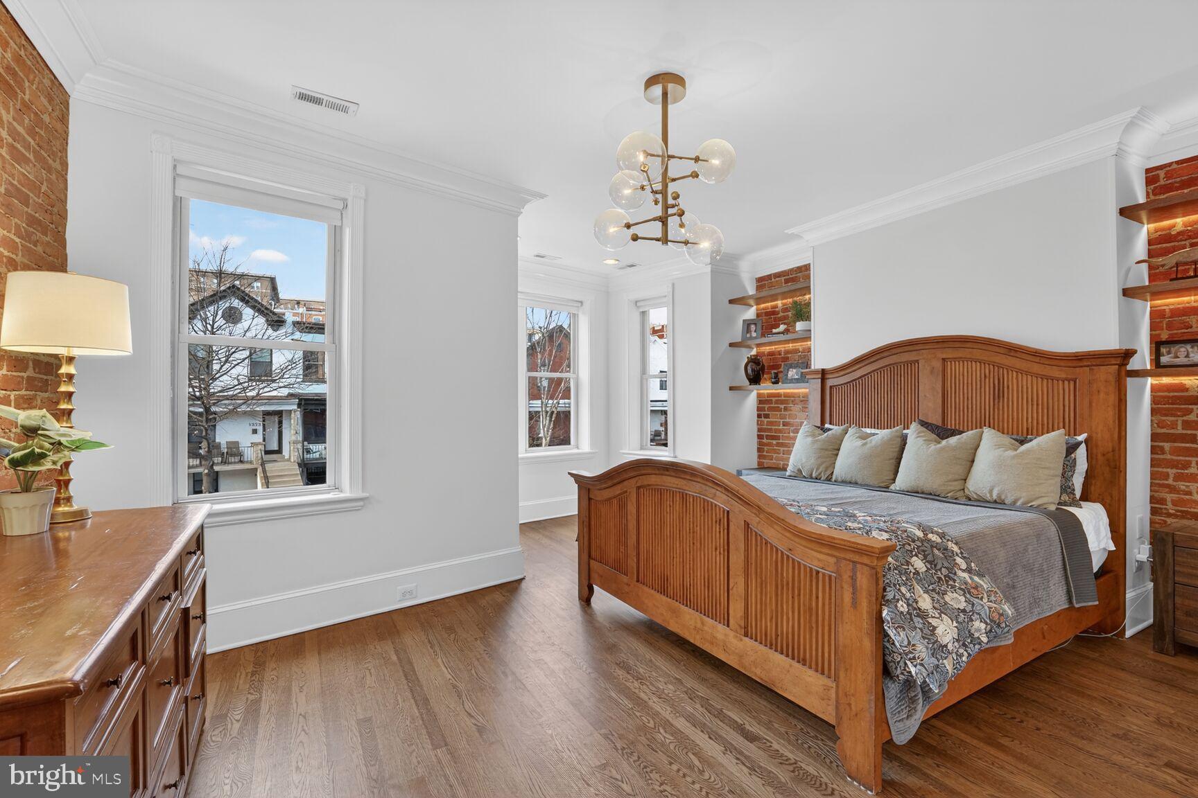 1316 Florida Avenue Northwest Washington, DC 20009 - Photo 15 of 43 a bedroom with a bed and wooden floor