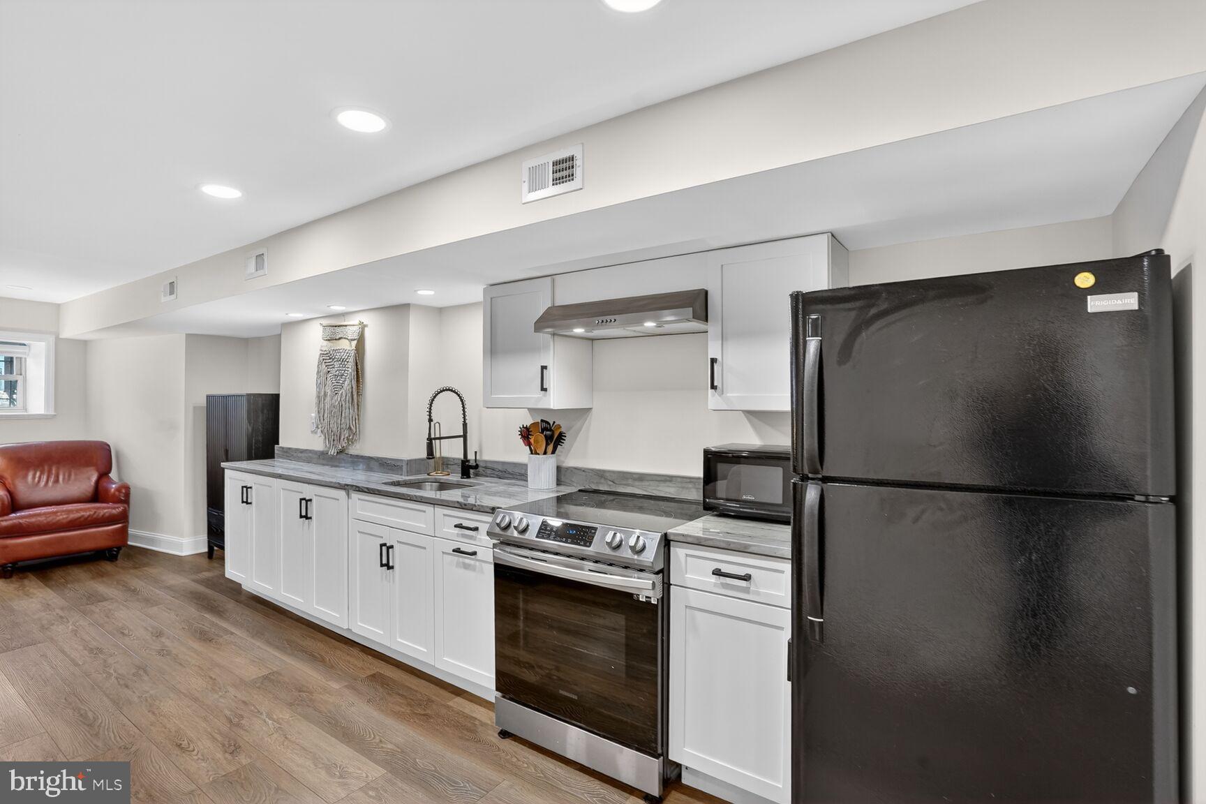 1316 Florida Avenue Northwest Washington, DC 20009 - Photo 27 of 43 a kitchen with stainless steel appliances granite countertop a refrigerator a sink a stove and a refrigerator