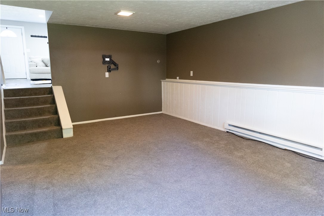 5861 Lee Avenue North Ridgeville, OH 44039 - Photo 14 of 20 Unfurnished room featuring baseboard heating, a textured ceiling, and carpet floors