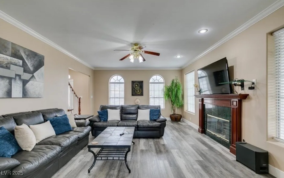 6520 Turtle Hill Road Las Vegas, NV 89110 - Photo 14 of 59 Living room featuring ornamental molding, healthy amount of natural light, light wood finished floors, a ceiling fan, and recessed lighting