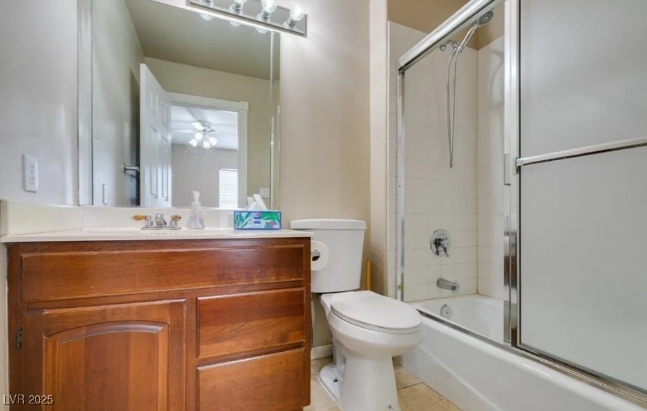 6520 Turtle Hill Road Las Vegas, NV 89110 - Photo 31 of 59 Full bath with bath / shower combo with glass door, vanity, and light tile patterned floors