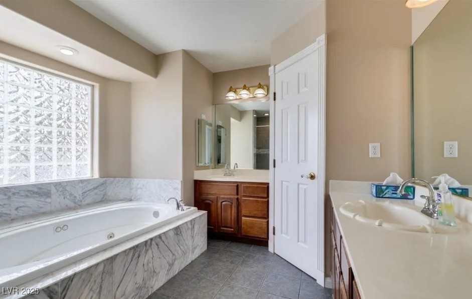 6520 Turtle Hill Road Las Vegas, NV 89110 - Photo 34 of 59 Full bath with vanity, a garden tub, and dark tile patterned floors