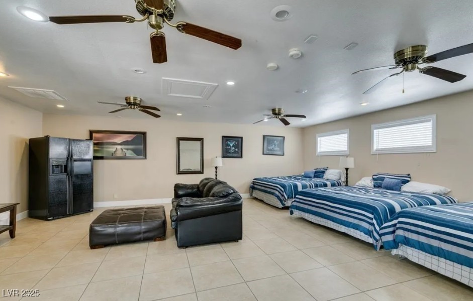 6520 Turtle Hill Road Las Vegas, NV 89110 - Photo 46 of 59 Bedroom with black refrigerator with ice dispenser, light tile patterned flooring, attic access, and recessed lighting