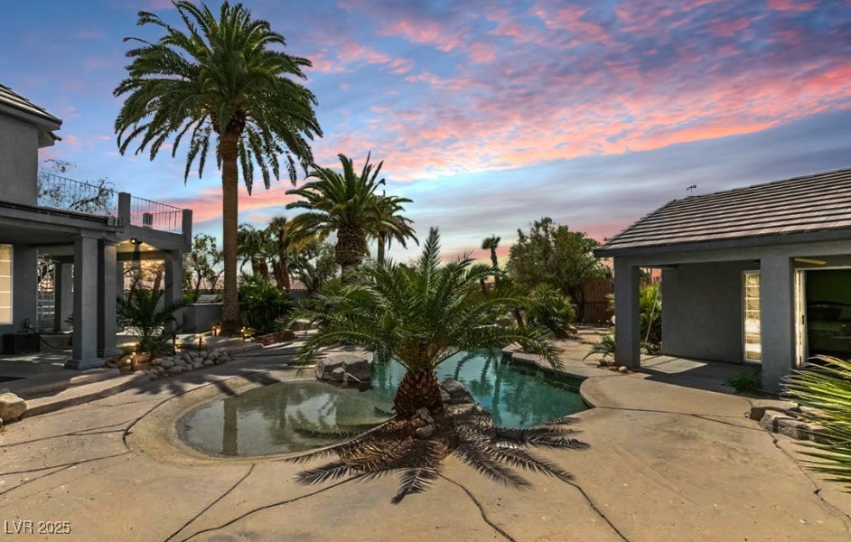6520 Turtle Hill Road Las Vegas, NV 89110 - Photo 57 of 59 Pool at dusk with a patio and an outdoor pool
