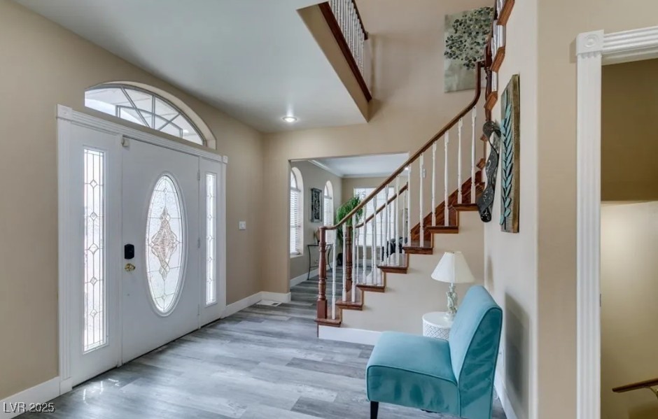 6520 Turtle Hill Road Las Vegas, NV 89110 - Photo 9 of 59 Foyer entrance featuring wood finished floors, healthy amount of natural light, and stairs