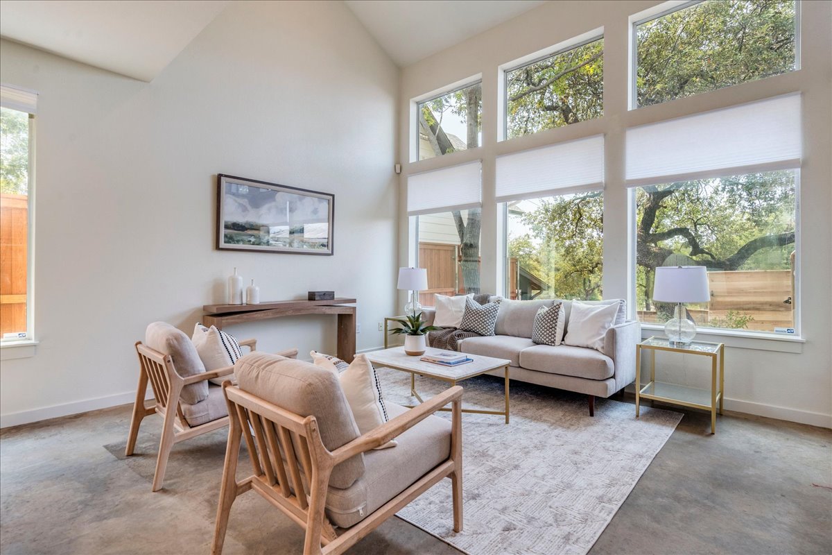 2811 Hardeman Street, Unit B Austin, TX 78704 - Photo 3 of 34 Towering windows and cathedral ceilings draw natural light across smooth concrete flooring.
