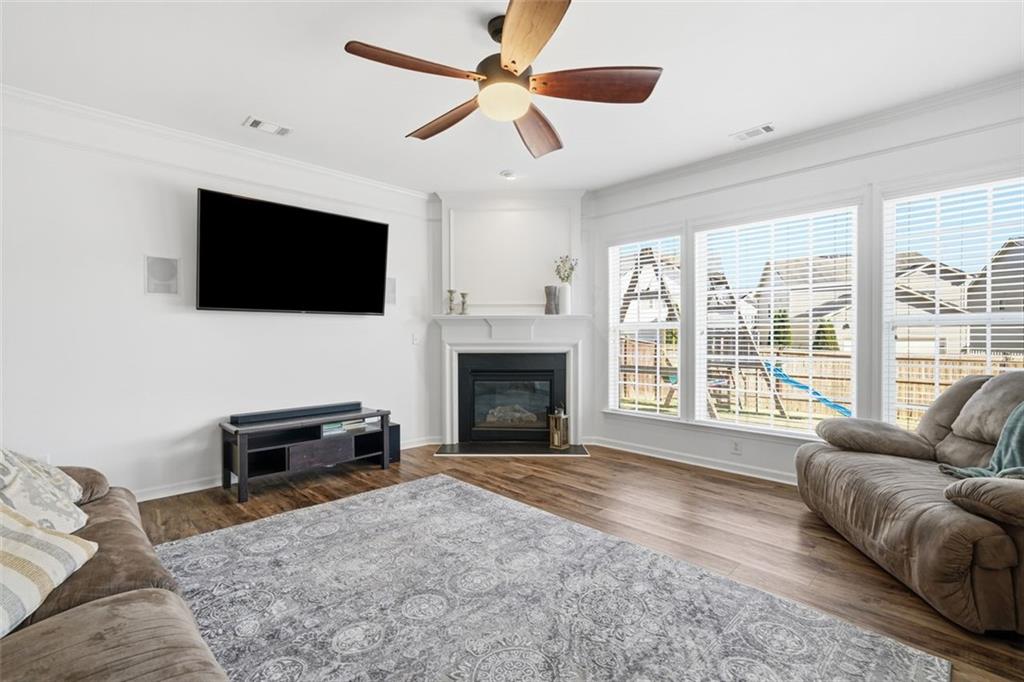 503 White Oak Path Canton, GA 30115 - Photo 13 of 47 a living room with furniture a flat screen tv and a fireplace