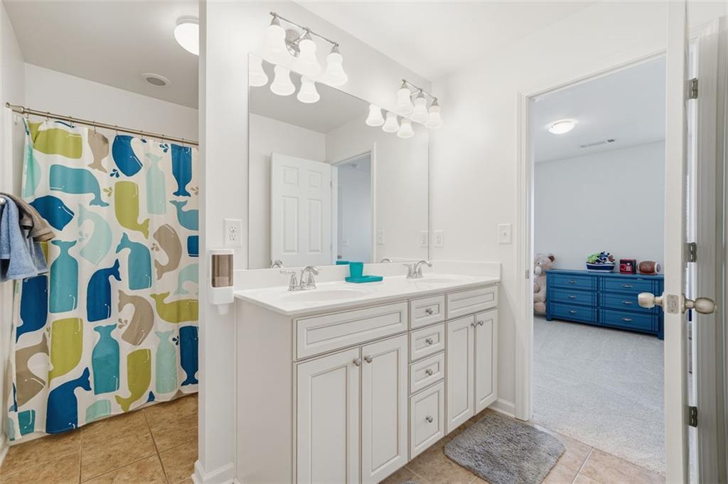 503 White Oak Path Canton, GA 30115 - Photo 22 of 47 a spacious bathroom with a sink double vanity and a mirror