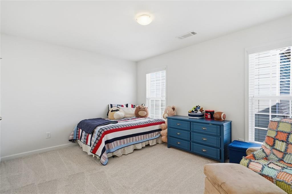 503 White Oak Path Canton, GA 30115 - Photo 25 of 47 a bed room with a bed dresser and a window