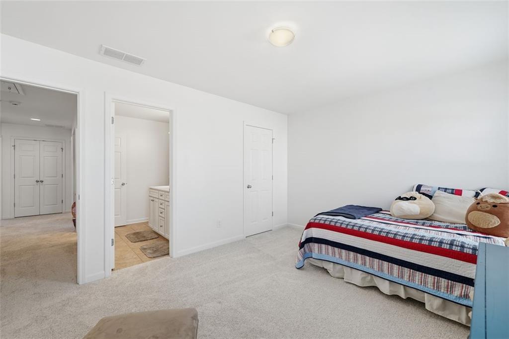 503 White Oak Path Canton, GA 30115 - Photo 26 of 47 a room with a bed and a lamp