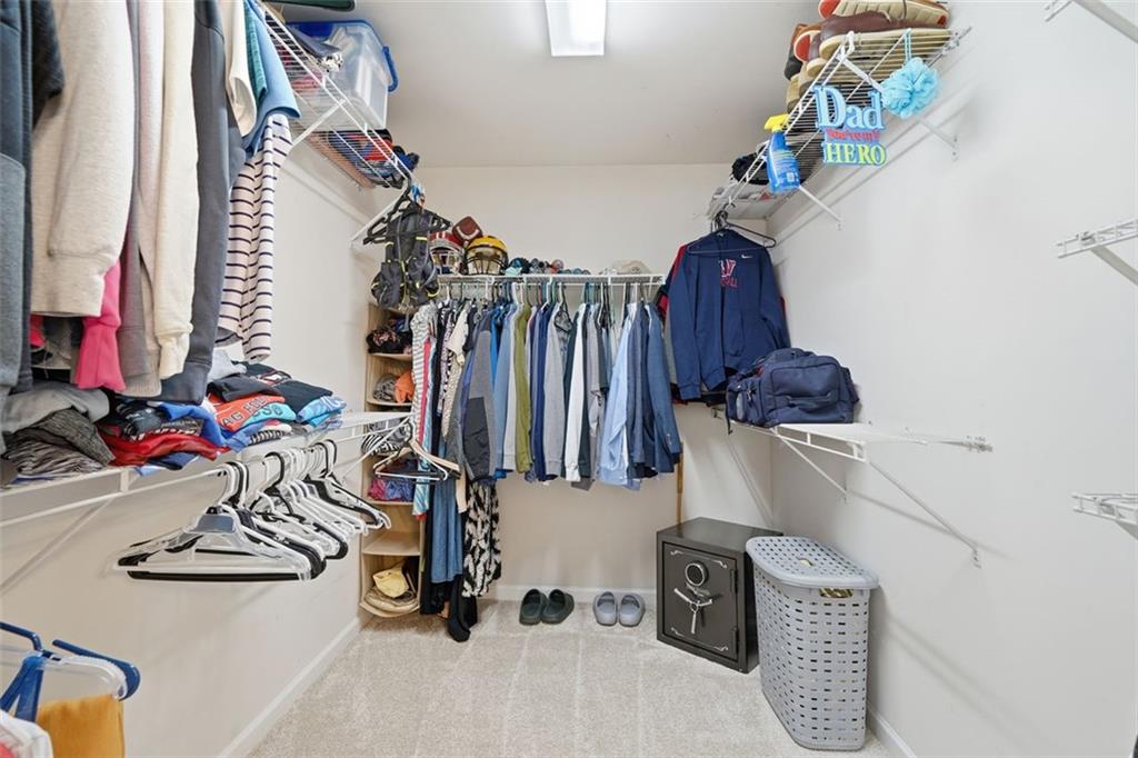 503 White Oak Path Canton, GA 30115 - Photo 34 of 47 a view of walk in closet with clothes and shoes