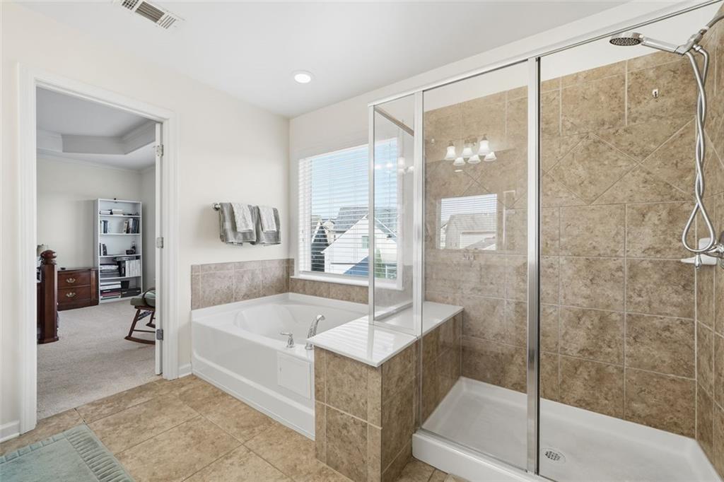 503 White Oak Path Canton, GA 30115 - Photo 36 of 47 a bathroom with a tub and shower