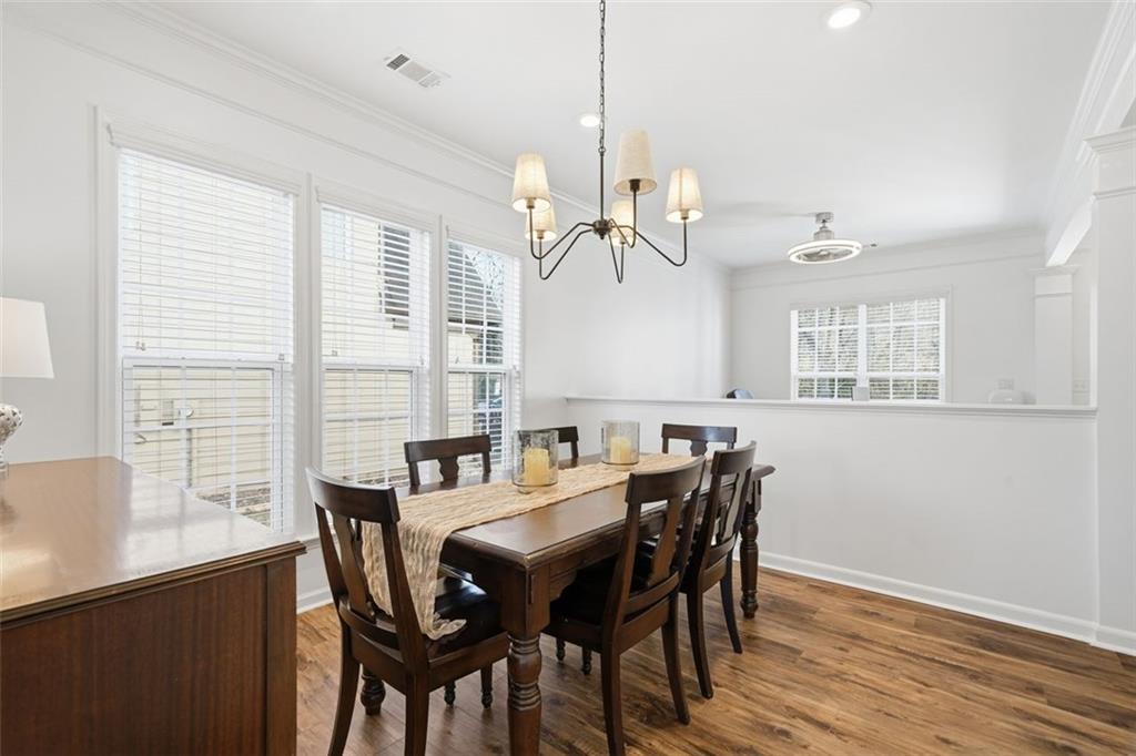 503 White Oak Path Canton, GA 30115 - Photo 10 of 47 a view of a dining room with furniture window and wooden floor