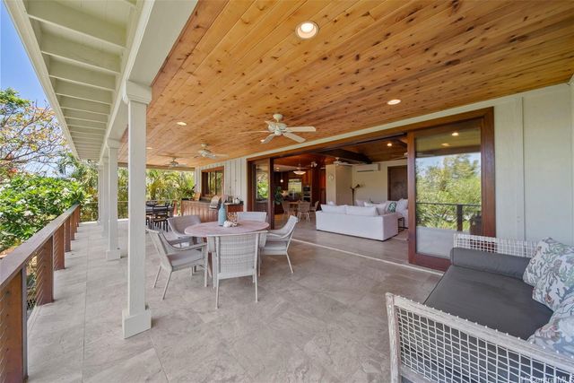 a outdoor space with lots of tables a large window and chairs