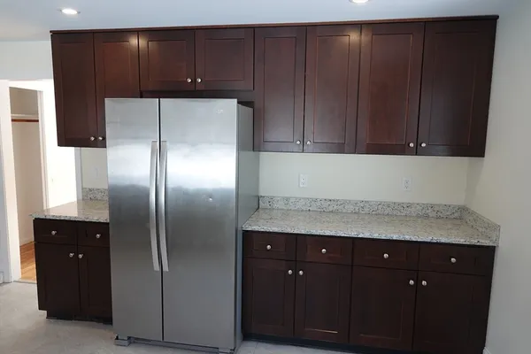 a kitchen with a refrigerator and cabinets