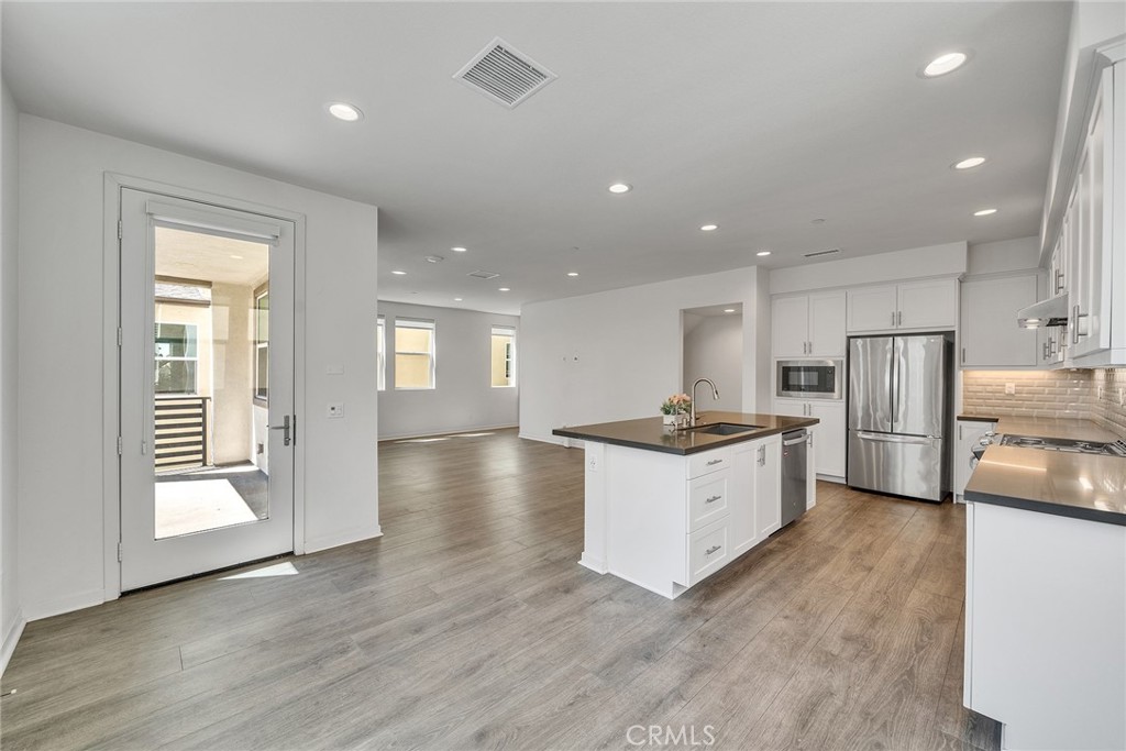 104 Tenor Irvine, CA 92618 - Photo 1 of 1 a large kitchen with granite countertop a large counter top a sink stainless steel appliances and cabinets