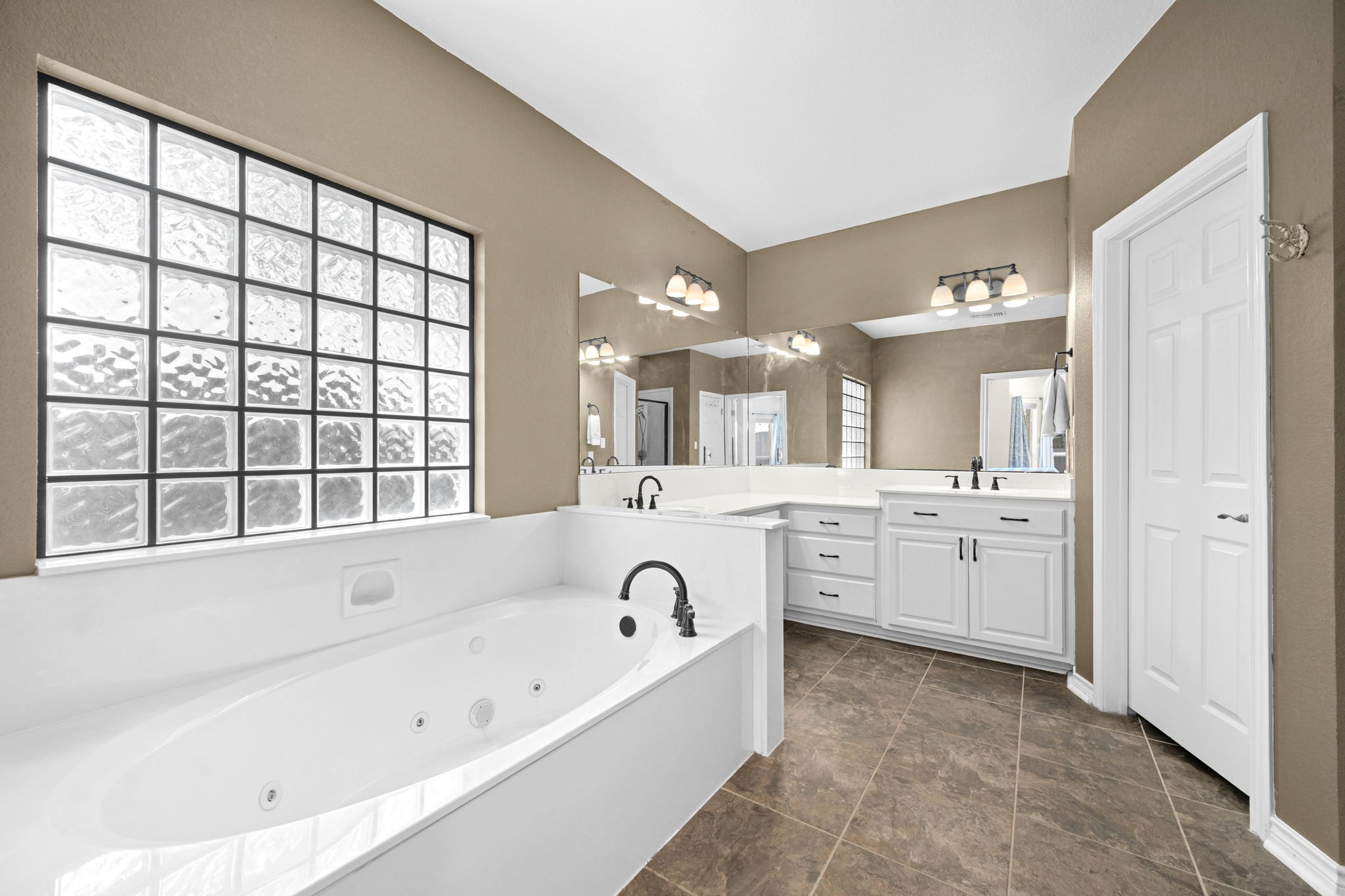 108 Thornwood Road Georgetown, TX 78628 - Photo 21 of 40 Indulge in a tranquil bathing experience in this spacious primary bathroom featuring a large soaking tub and abundant counter space.