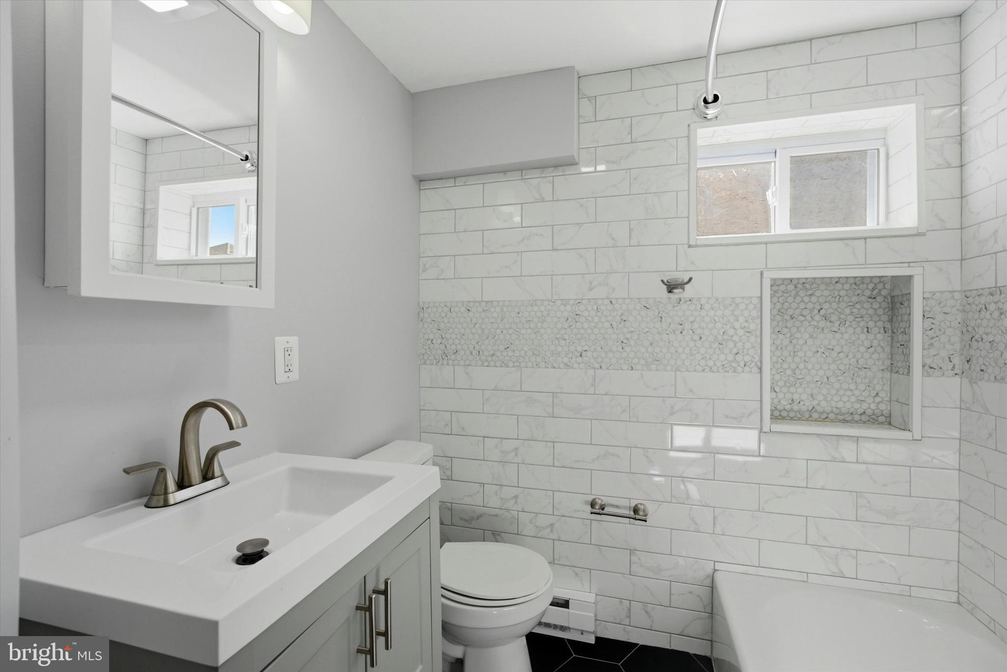 106 West 5th Street Bridgeport, PA 19405 - Photo 20 of 26 a bathroom with a sink a toilet and shower