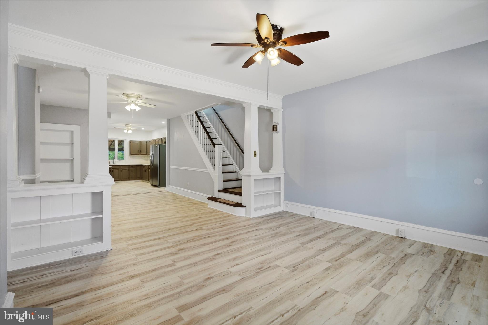 106 West 5th Street Bridgeport, PA 19405 - Photo 5 of 26 a view of an empty room with stairs and a ceiling fan