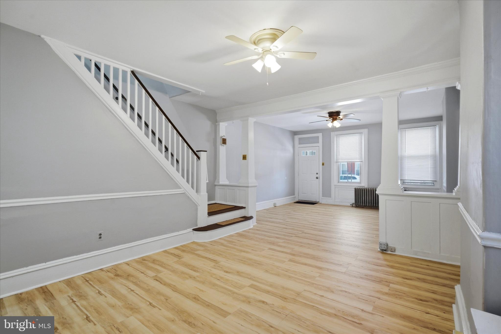 106 West 5th Street Bridgeport, PA 19405 - Photo 6 of 26 a view of an empty room with wooden floor and a chandelier