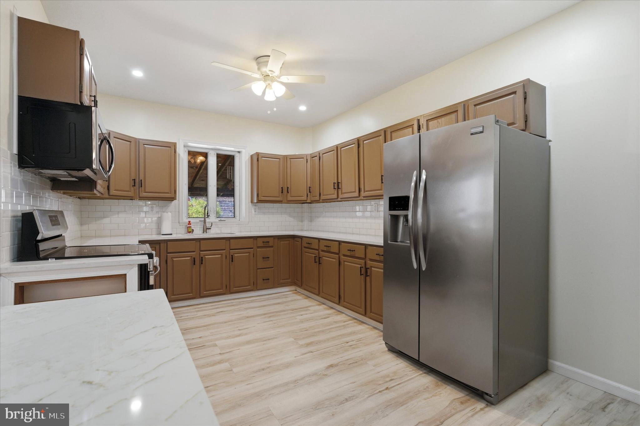 106 West 5th Street Bridgeport, PA 19405 - Photo 8 of 26 a large kitchen with cabinets a sink and stainless steel appliances