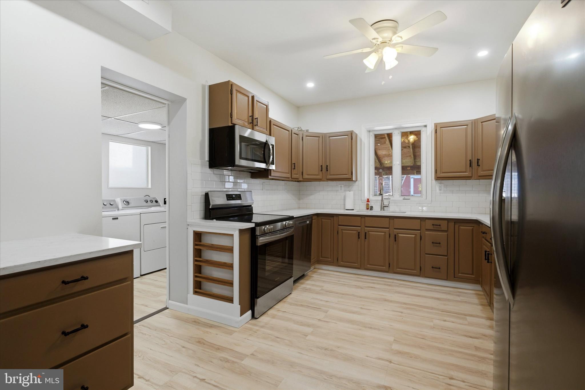106 West 5th Street Bridgeport, PA 19405 - Photo 9 of 26 a large kitchen with stainless steel appliances granite countertop a stove a sink and a refrigerator