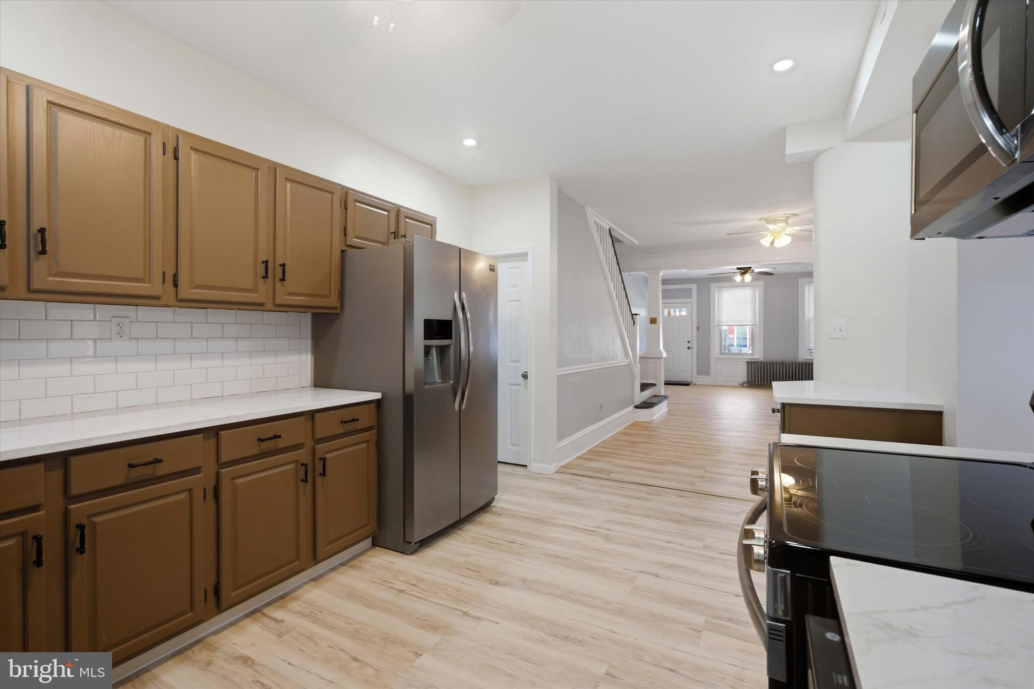 106 West 5th Street Bridgeport, PA 19405 - Photo 10 of 26 a kitchen with stainless steel appliances granite countertop a refrigerator and a sink