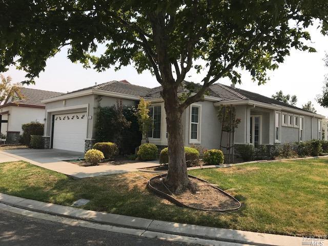 a view of a house with backyard and tree s