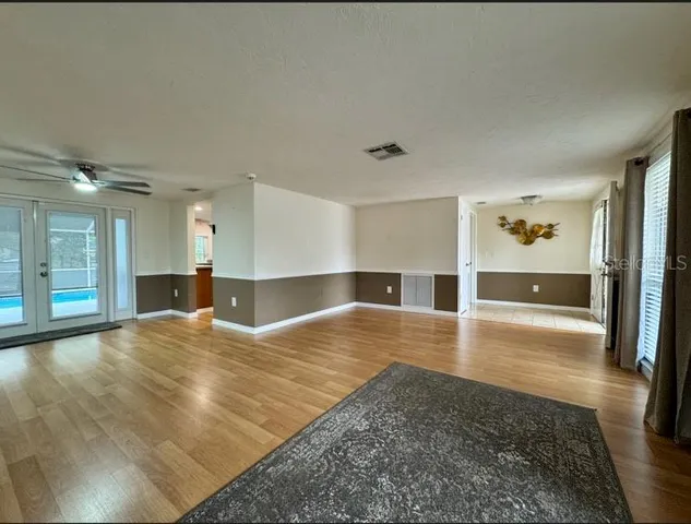 a view of a kitchen and an empty room