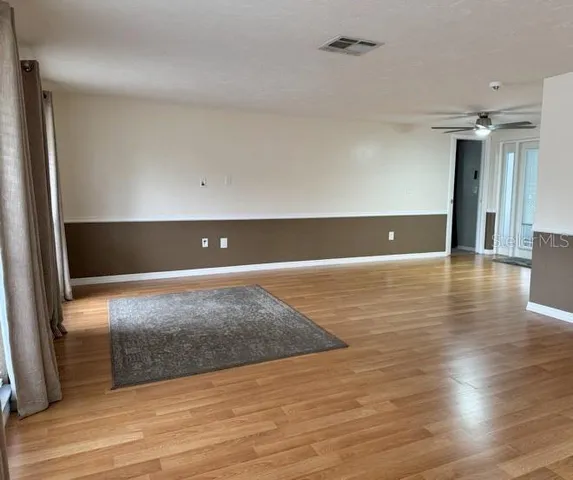 a view of a kitchen with wooden floor