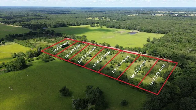an aerial view of a golf course with a lake view