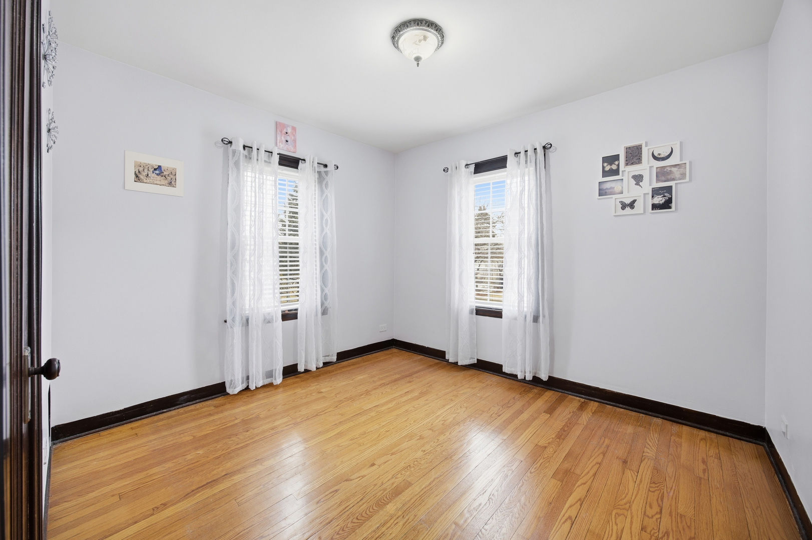 2557 Oak Street River Grove, IL 60171 - Photo 12 of 42 an empty room with wooden floor and windows