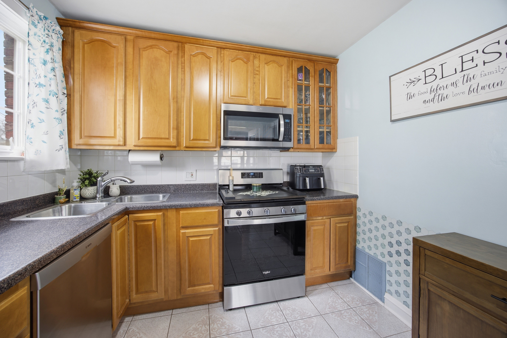 2557 Oak Street River Grove, IL 60171 - Photo 9 of 42 a kitchen with stainless steel appliances granite countertop a stove a sink and a microwave