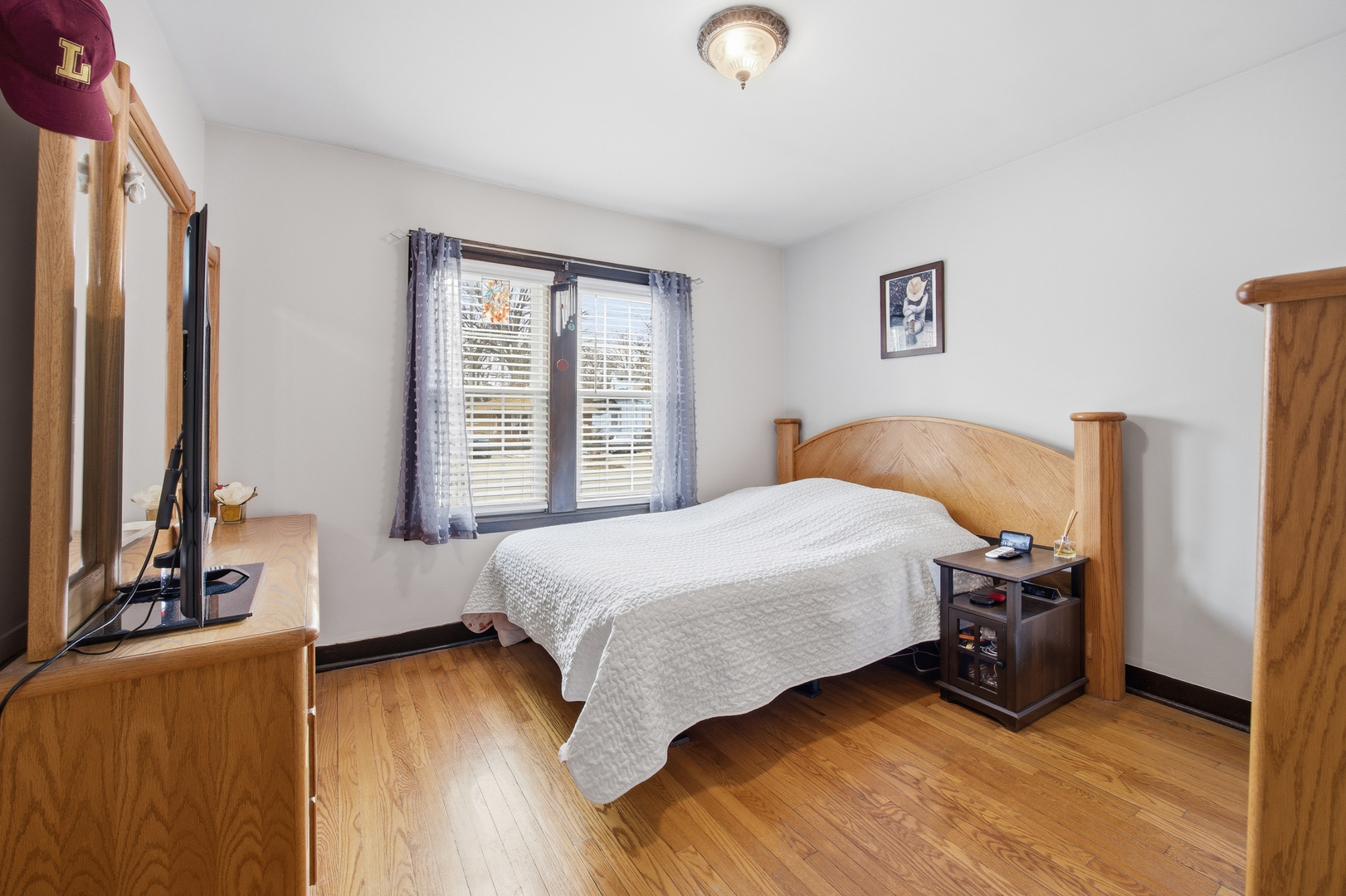 2557 Oak Street River Grove, IL 60171 - Photo 10 of 42 a bedroom with a bed and wooden floor