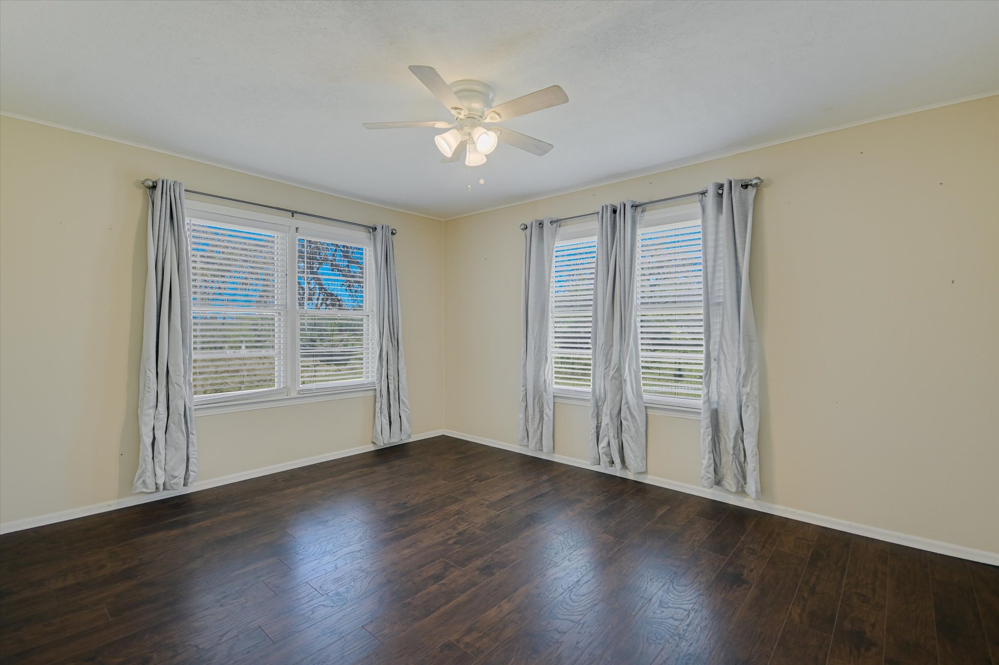 5421 Purgatory Road San Marcos, TX 78666 - Photo 9 of 38 a view of an empty room with wooden floor and a window