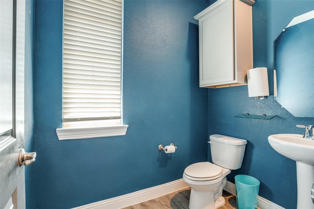 10421 Table Blf Street Aubrey, TX 76227 - Photo 12 of 25 a white toilet sitting next to a bathroom sink