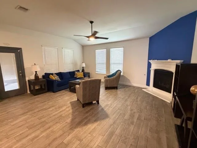 a living room with furniture a fireplace and a chandelier