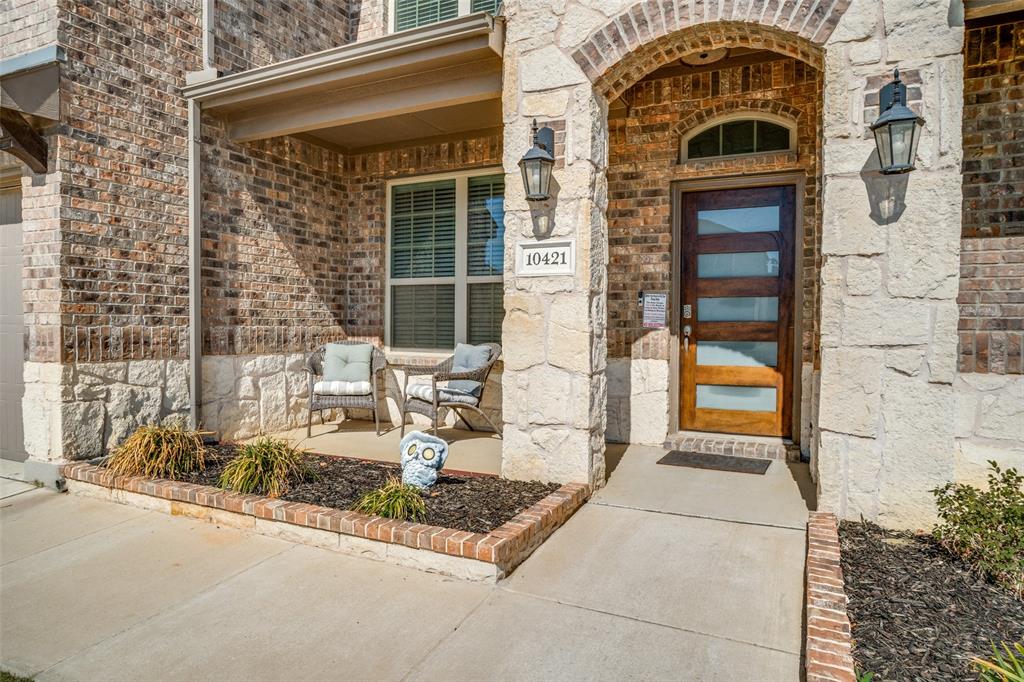 10421 Table Blf Street Aubrey, TX 76227 - Photo 2 of 25 a front view of a house with a yard
