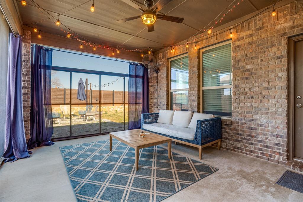 10421 Table Blf Street Aubrey, TX 76227 - Photo 22 of 25 a outdoor living space with a bell a clock and a rug
