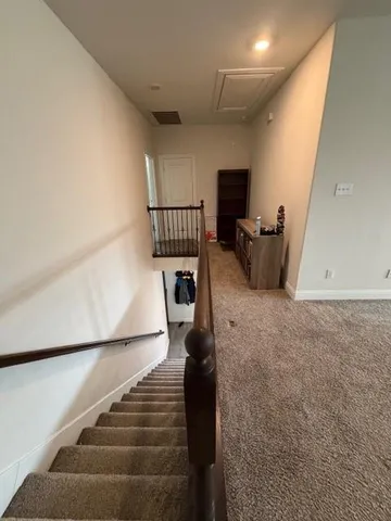 a view of a bedroom with cabinet and mirror