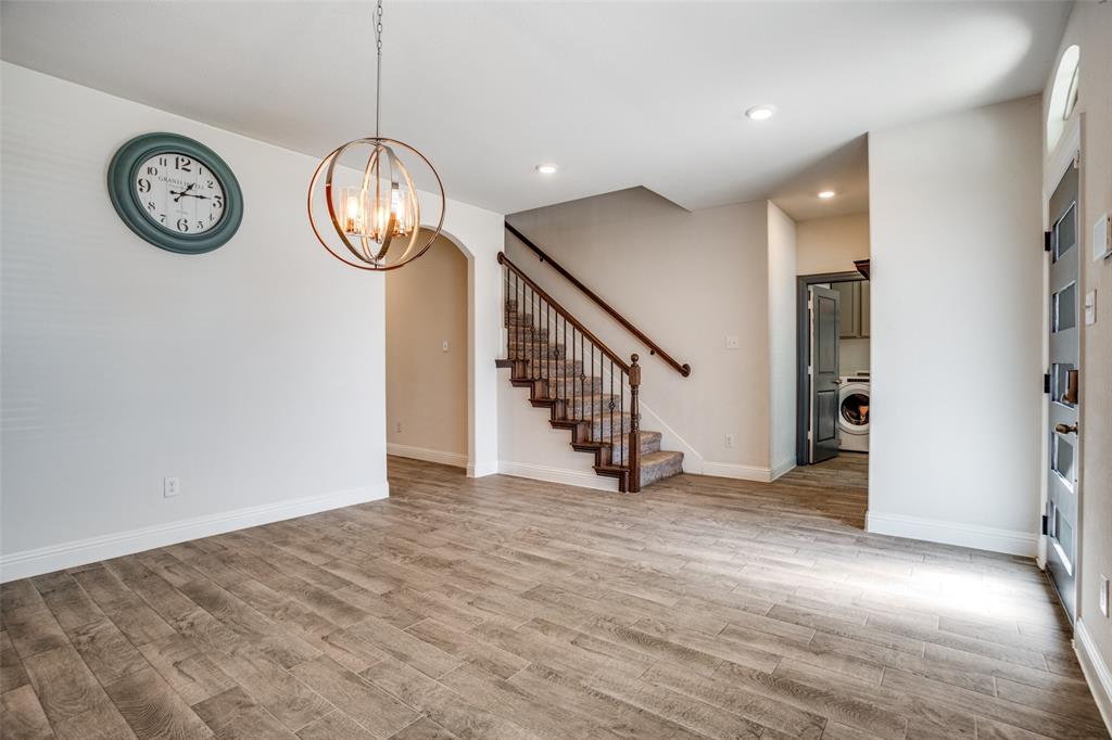 10421 Table Blf Street Aubrey, TX 76227 - Photo 4 of 25 an empty space with wooden floor and a window