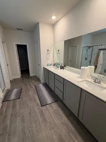 a bathroom with a double vanity sink and mirror