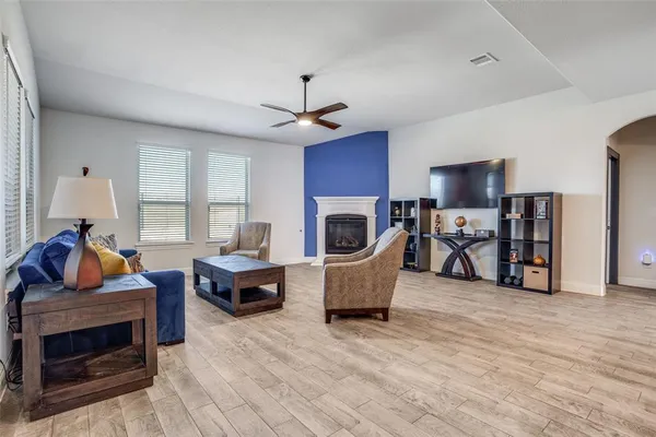 a living room with furniture a fireplace and a flat screen tv