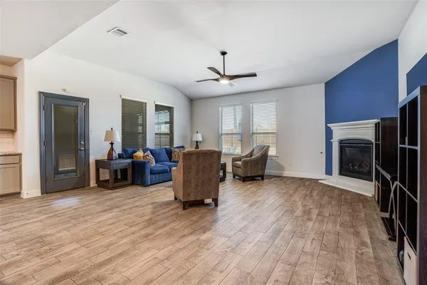 a bed sitting in a room next to a lamp