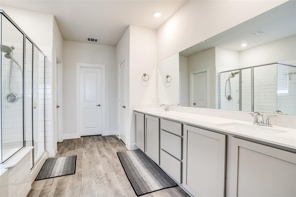 10421 Table Blf Street Aubrey, TX 76227 - Photo 10 of 25 a bathroom with a sink and a mirror